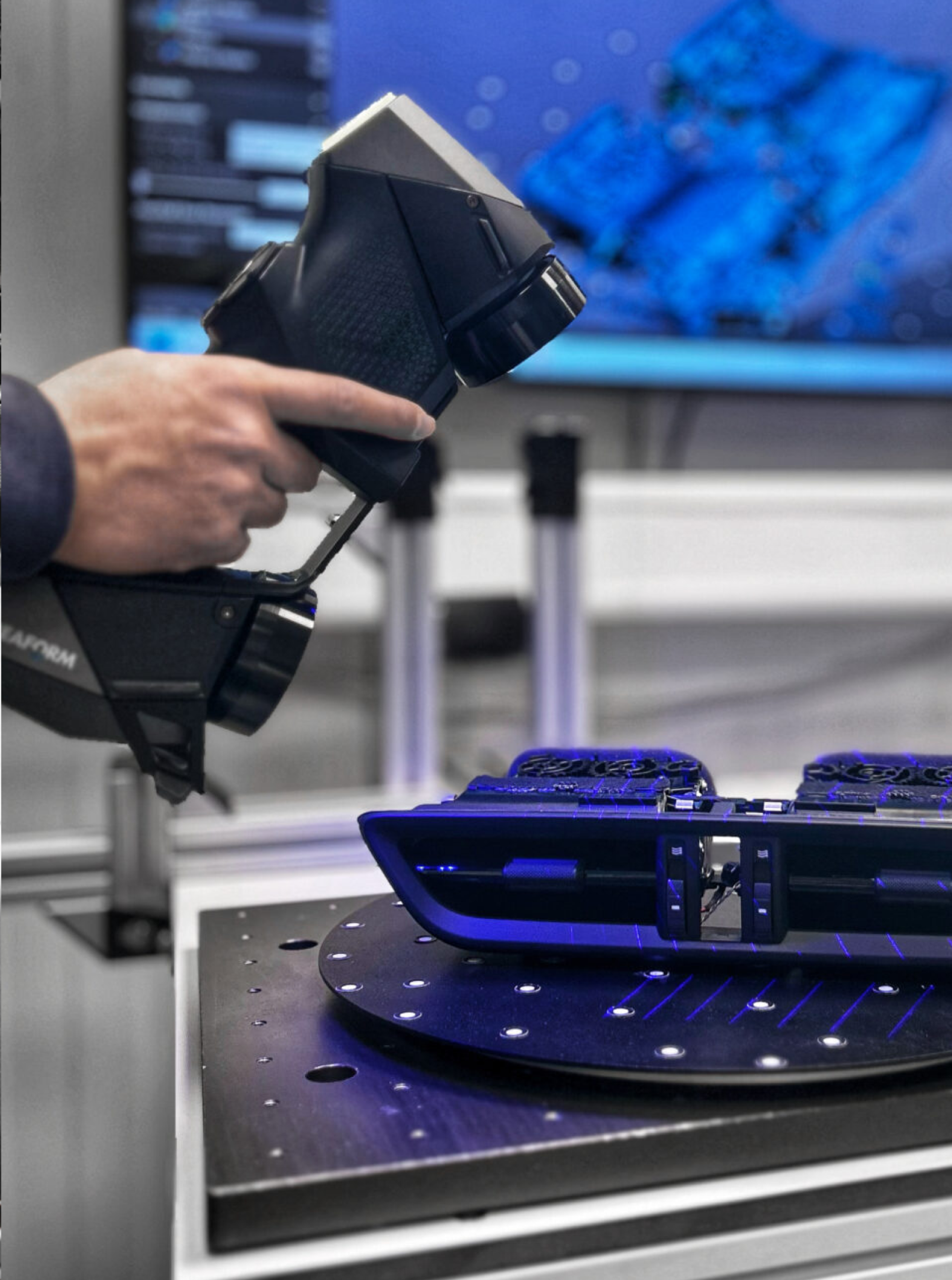 Eine Person, die ein Formular mit einem FARO-3D-Scanner scannt, wobei ein blauer Lasereffekt auf der Oberfläche des zu scannenden Objekts sichtbar ist.