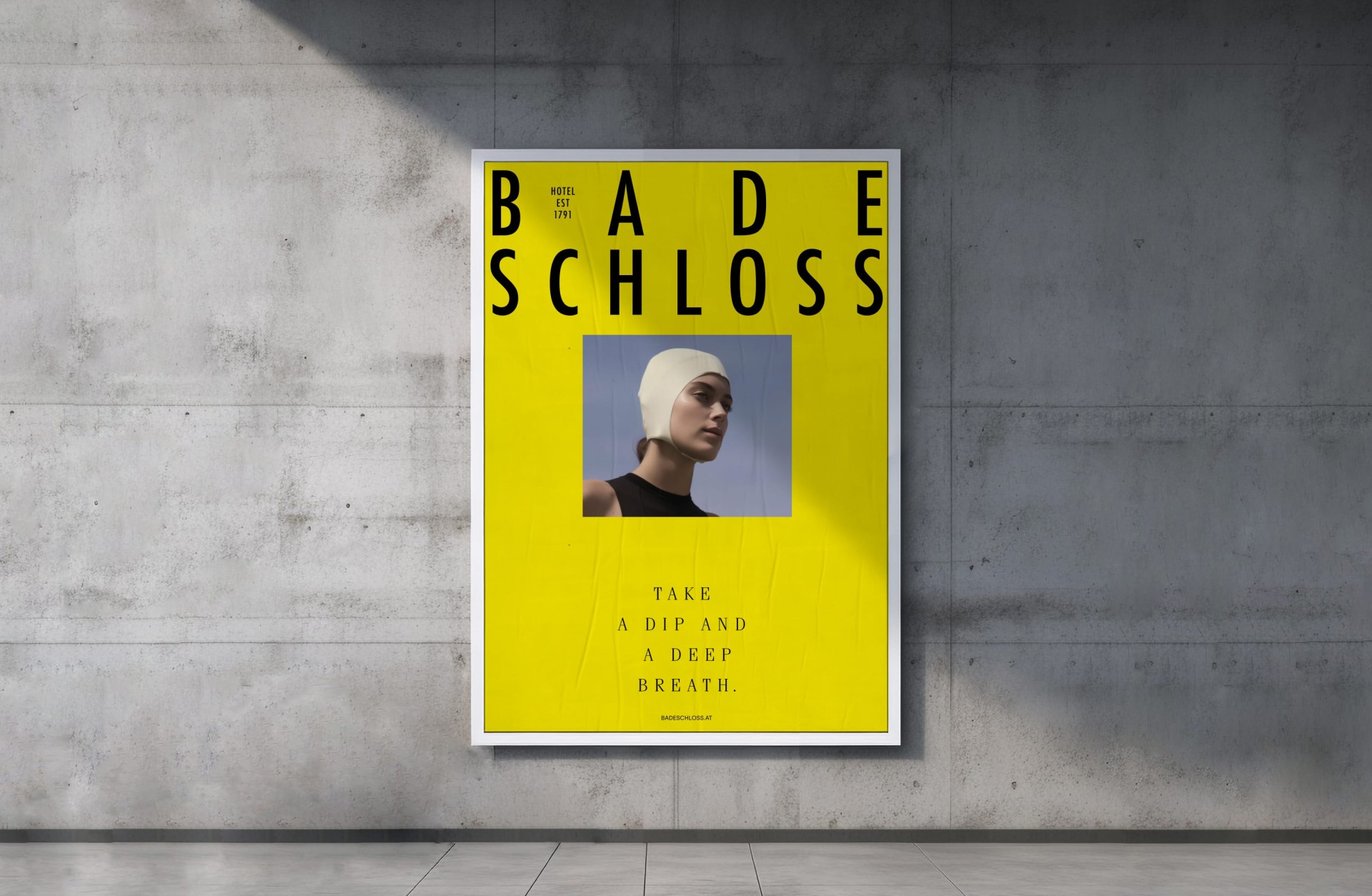 Gelbes Badeschloss Hotel 1791 Poster an einer Betonwand. Frau mit Badekappe. Text: „Nehmen Sie ein Bad und atmen Sie tief durch."